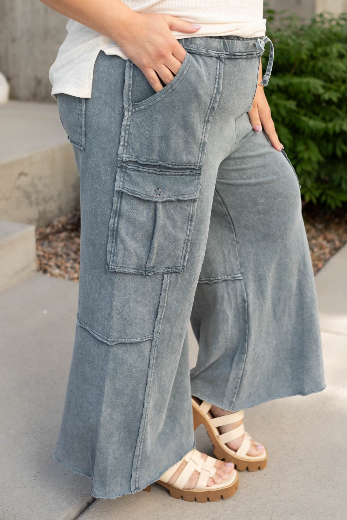 Side view of the plus size faded blue wide leg pants