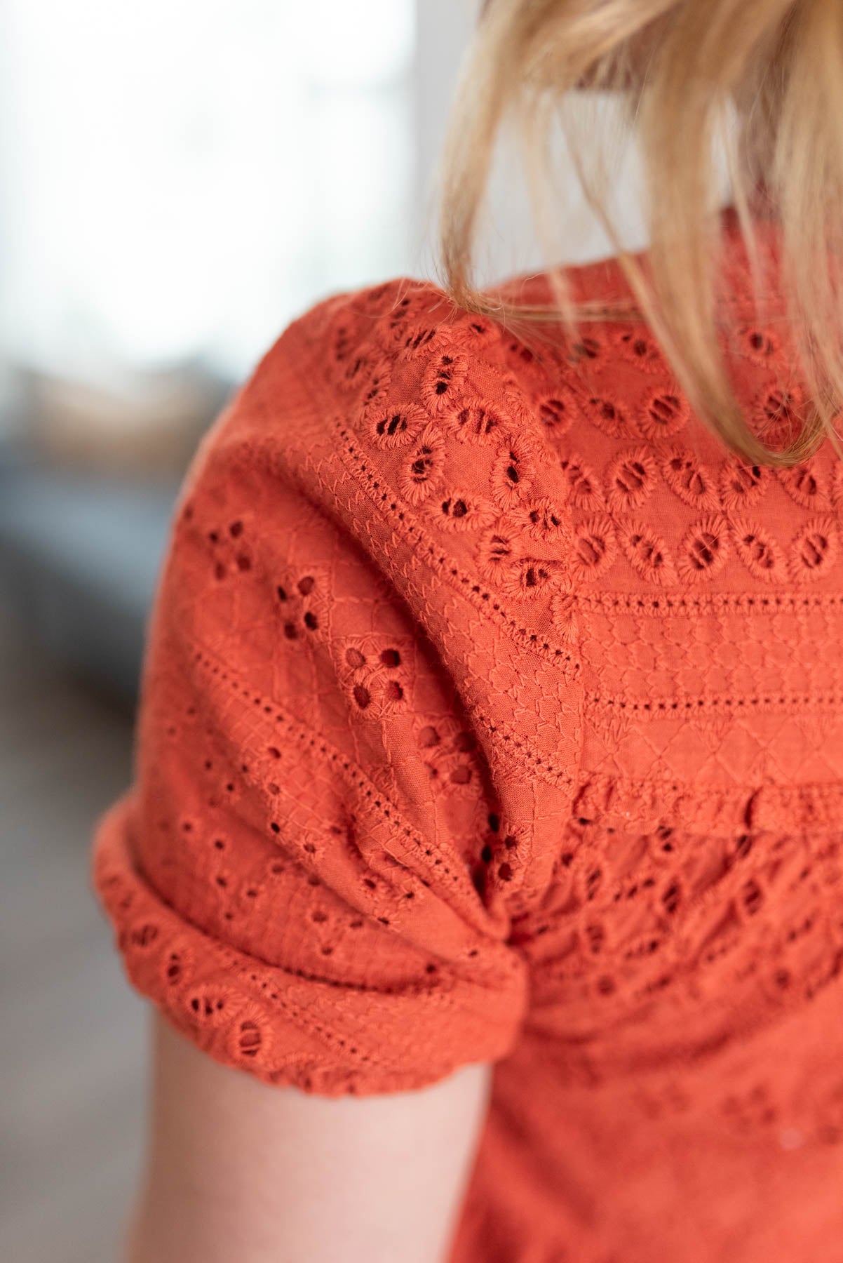 Close up of the eyelet fabric on the ginger orange dress