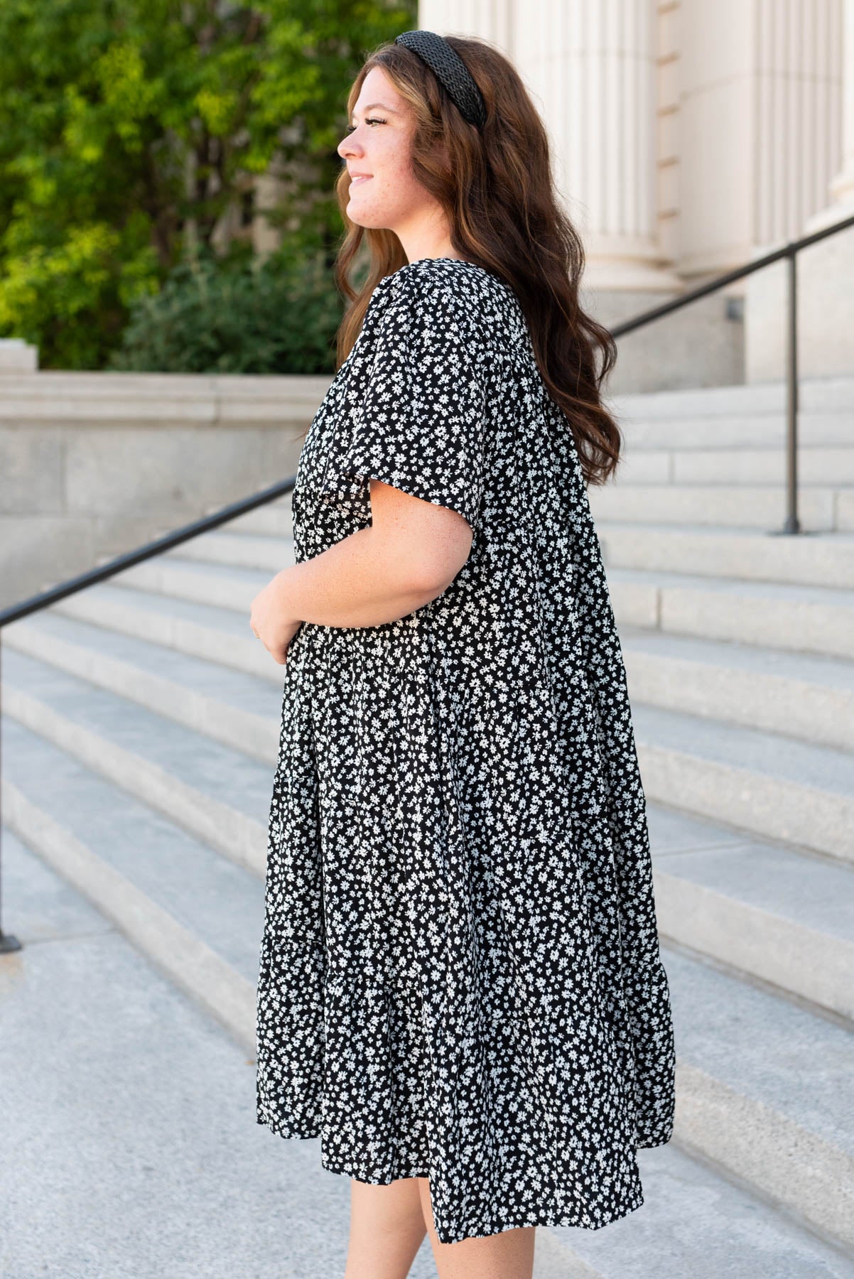 Side view of the plus size black ditsy floral dress