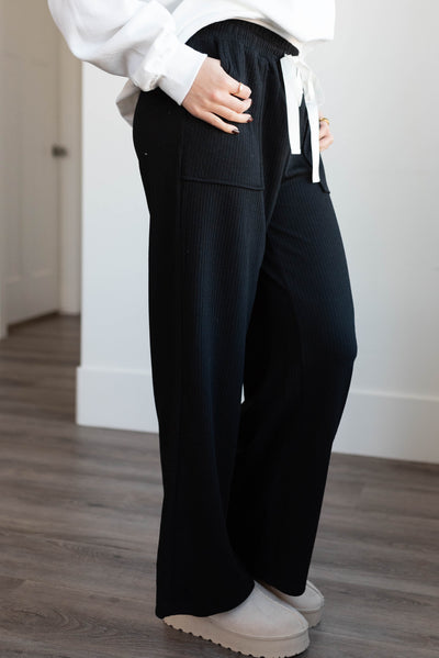 Side view of the black ribbed pants