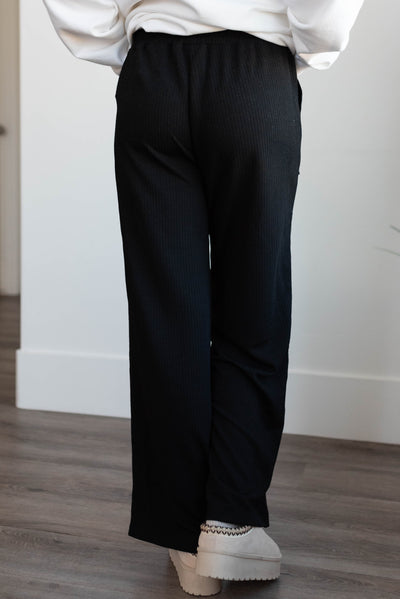 Back view of the black ribbed pants