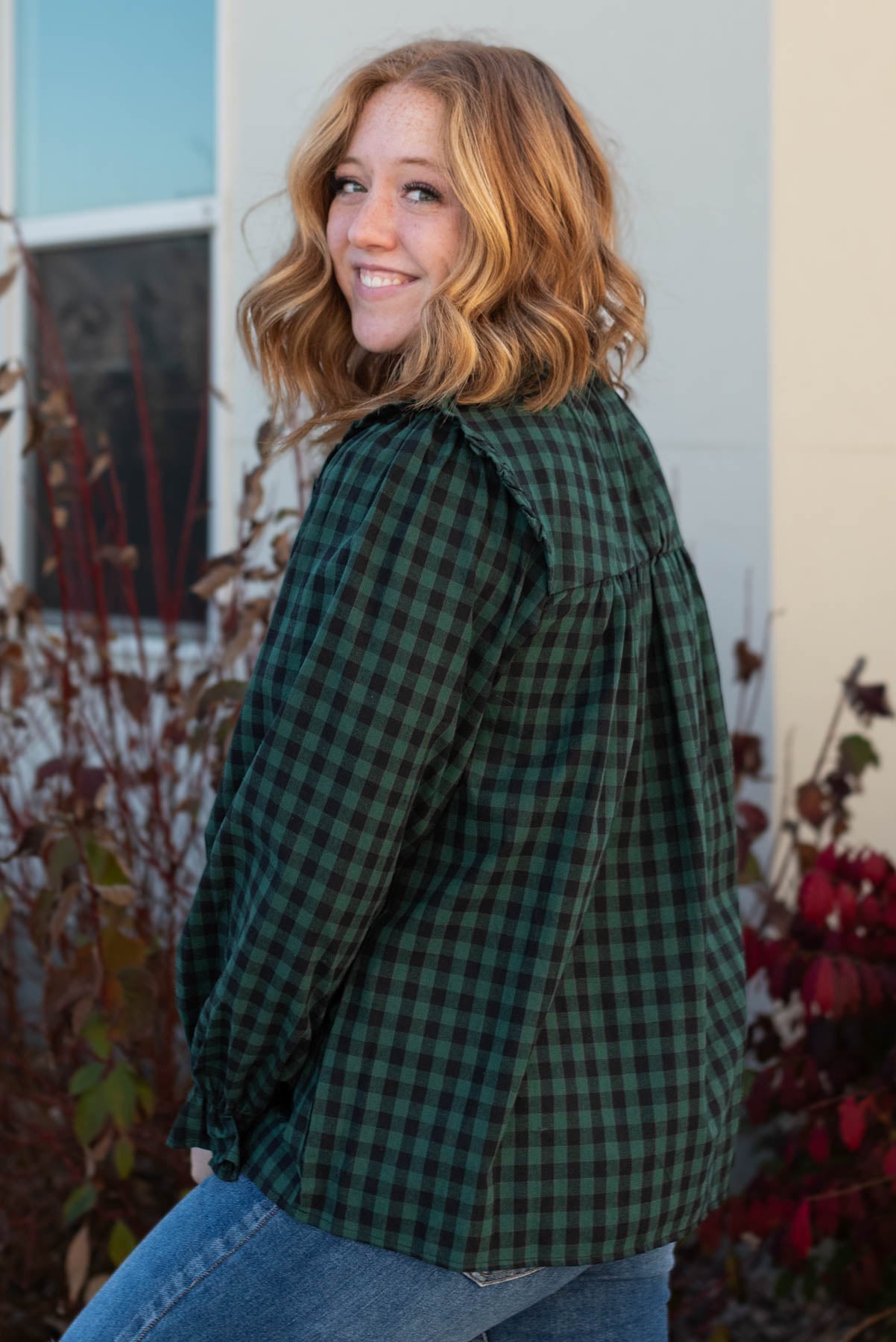 Side view of the hunter green ruffle blouse