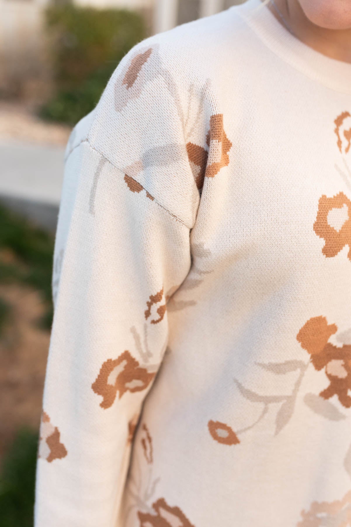 Close up of the sleeve on the oatmeal floral sweater