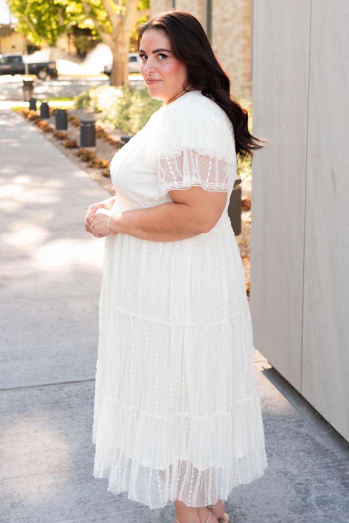 Side view of the plus size cream lace dress