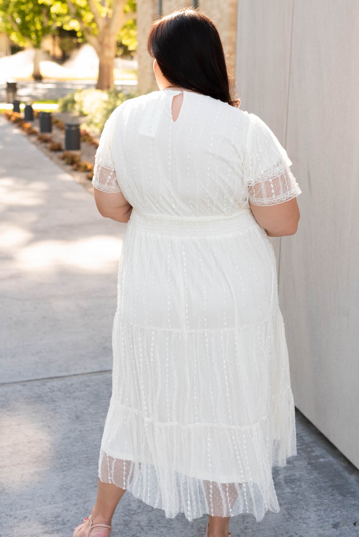 Back view of the plus size cream lace dress