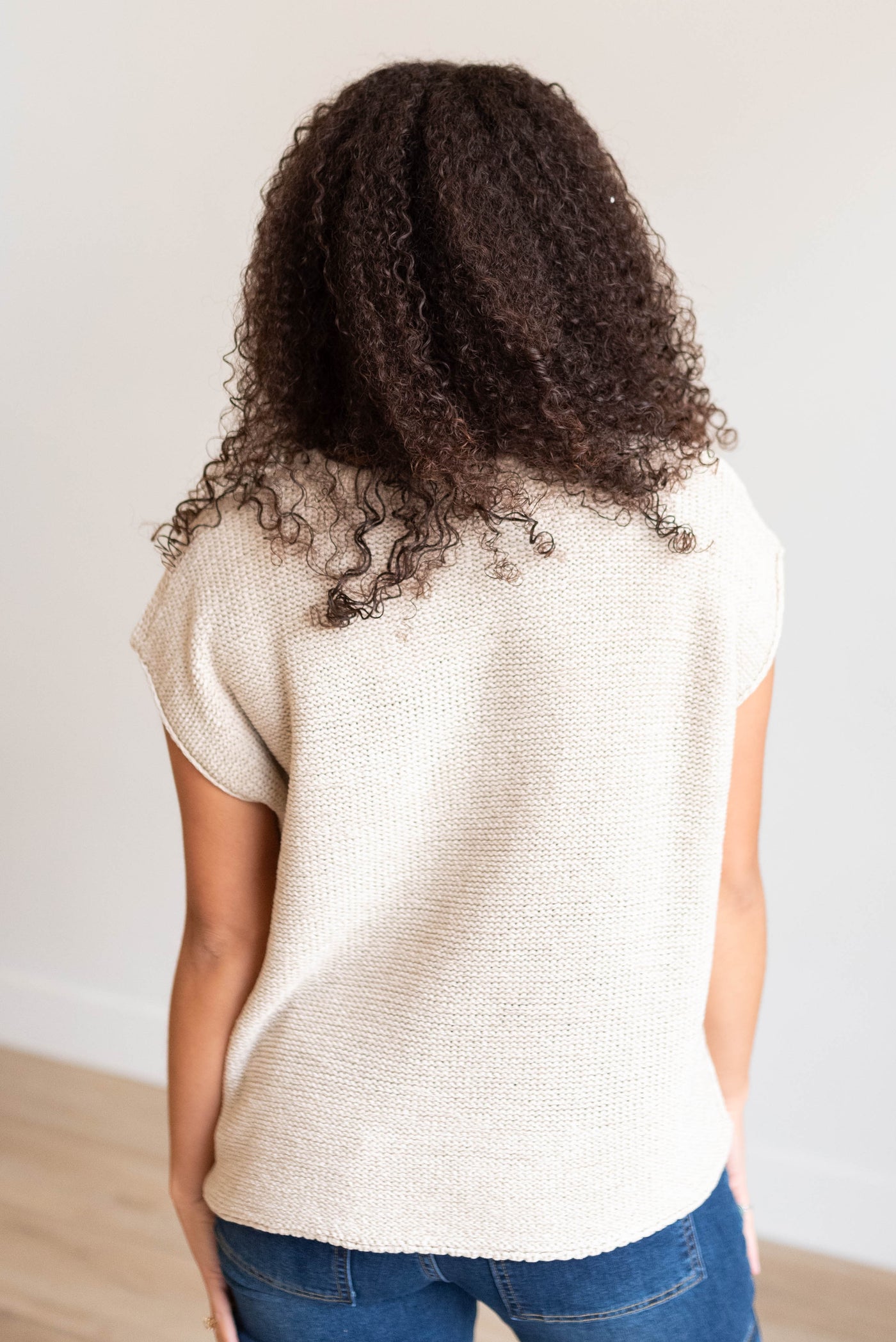 Back view of the sand biege sweater vest