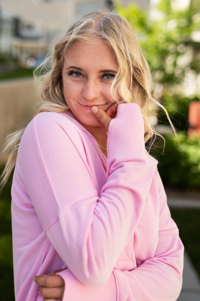 Pink hoodie with thumb holes in the cuffs