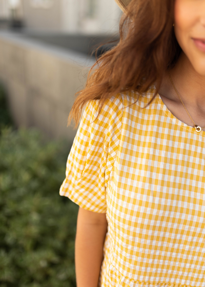 Sleeve of a yellow dress