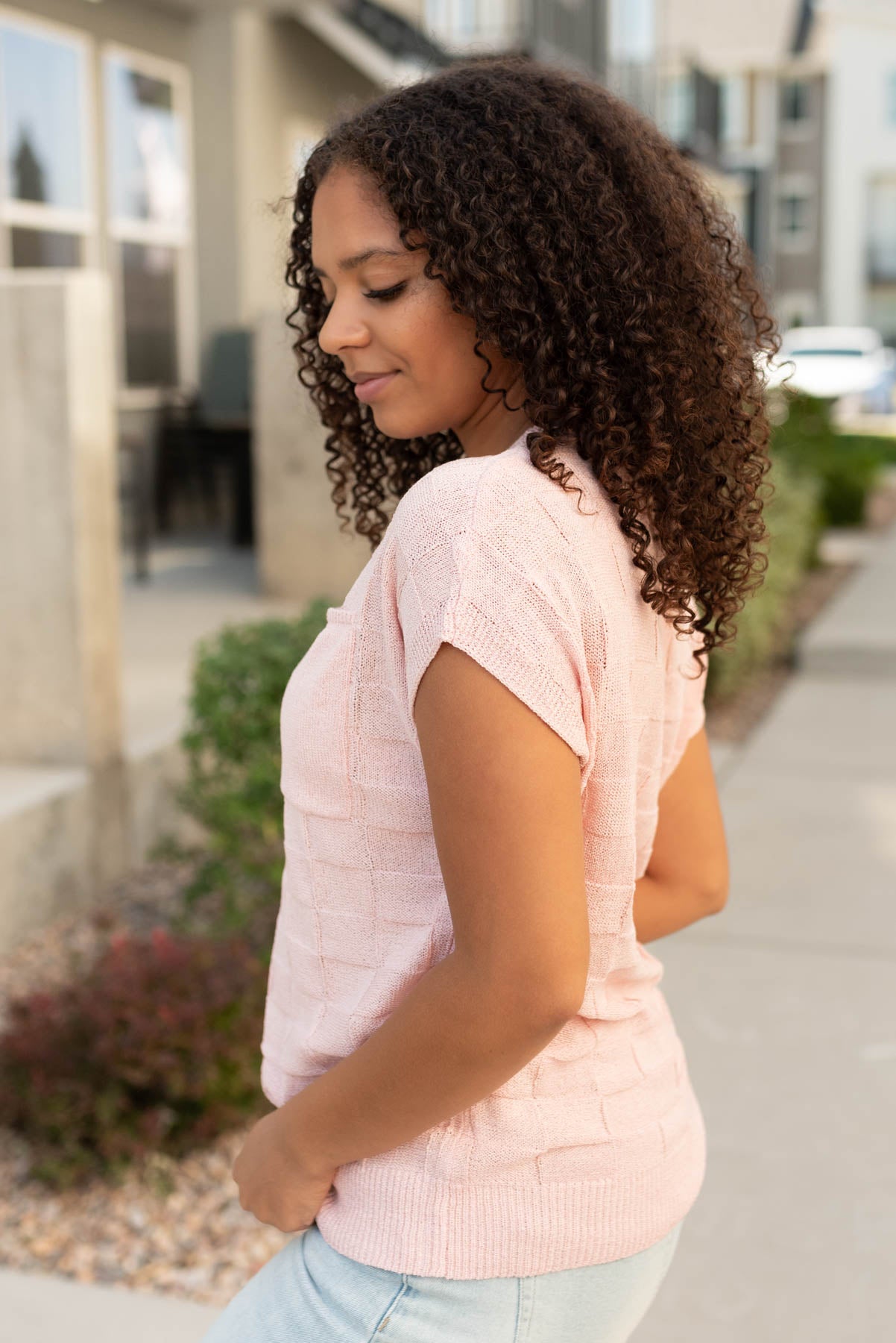 Side view of the dusty pink sweater vest