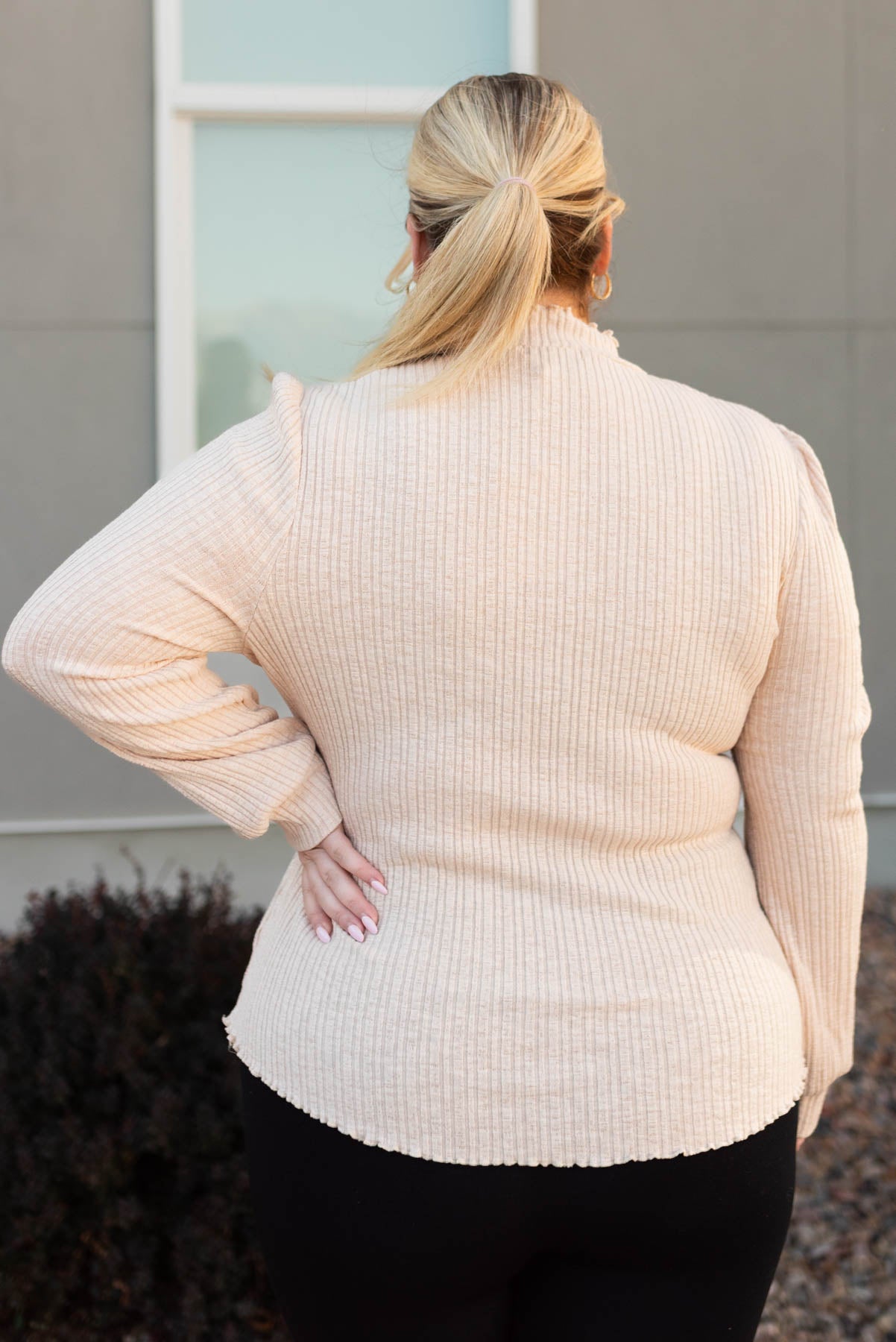 Back view of a plus size cream top