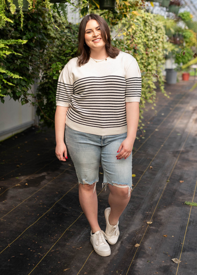 front view of the plus size white stripe sweater