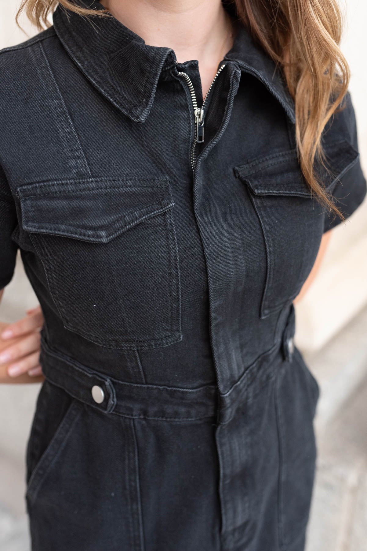 Close up of the pockets on the black denim zipper dress