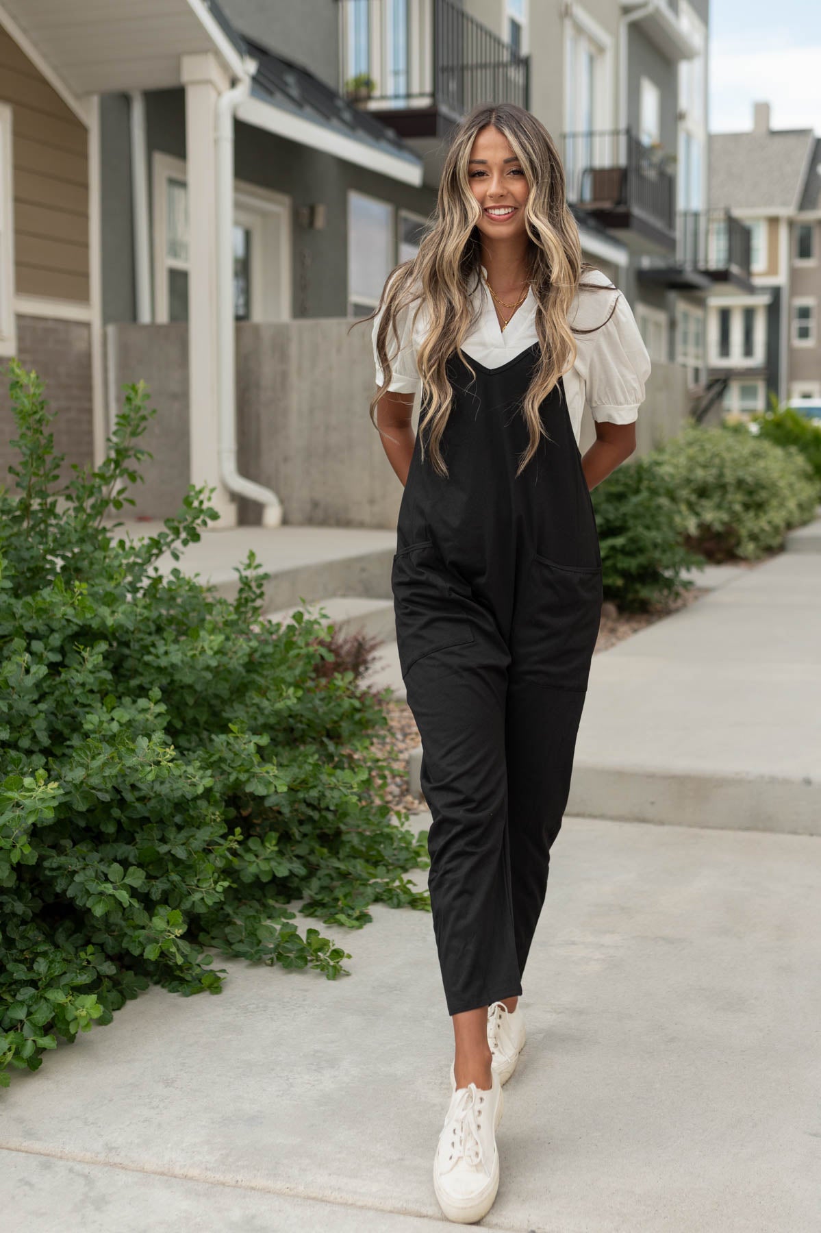 Black jumpsuit with pockets, tapered leg and slight v-neck