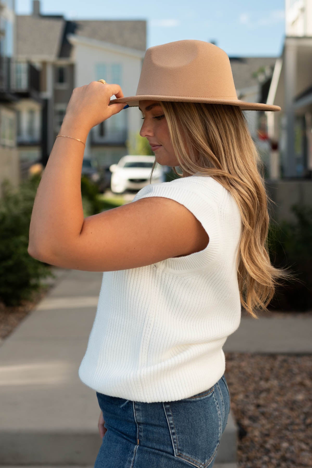 Side view of a white sweater vest