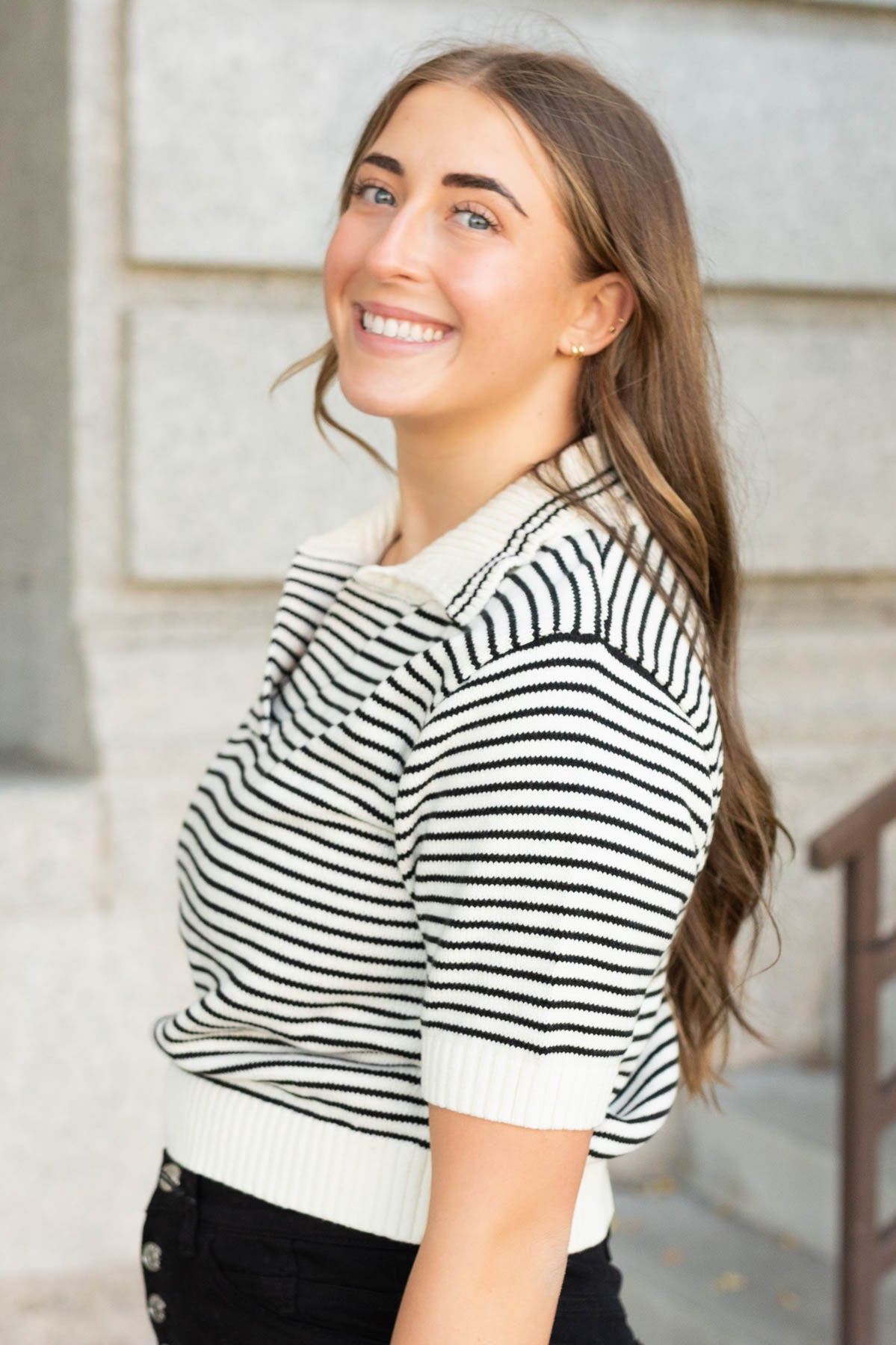 Side view of the black stripe collared sweater