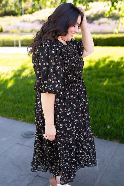 Side view of the black floral smocked dress