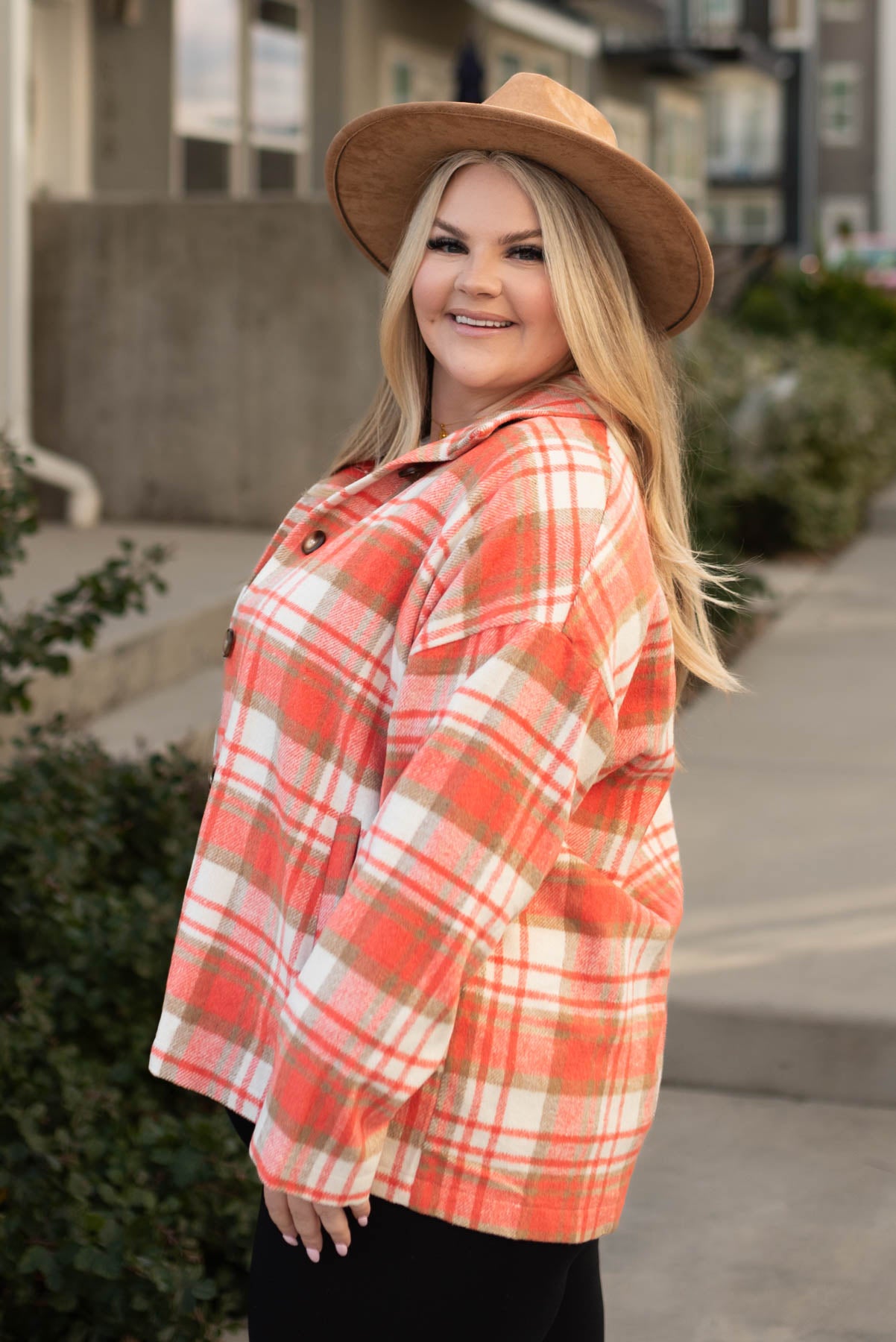 Side view of a plus size coral plaid shacket