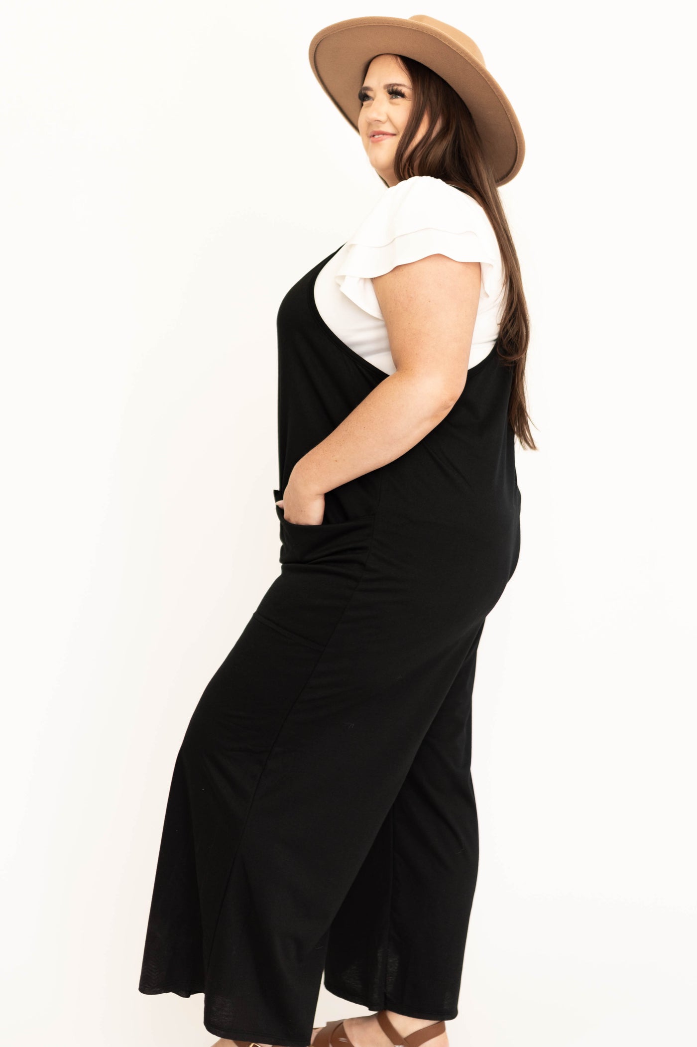 Side view of a plus size black jumpsuit