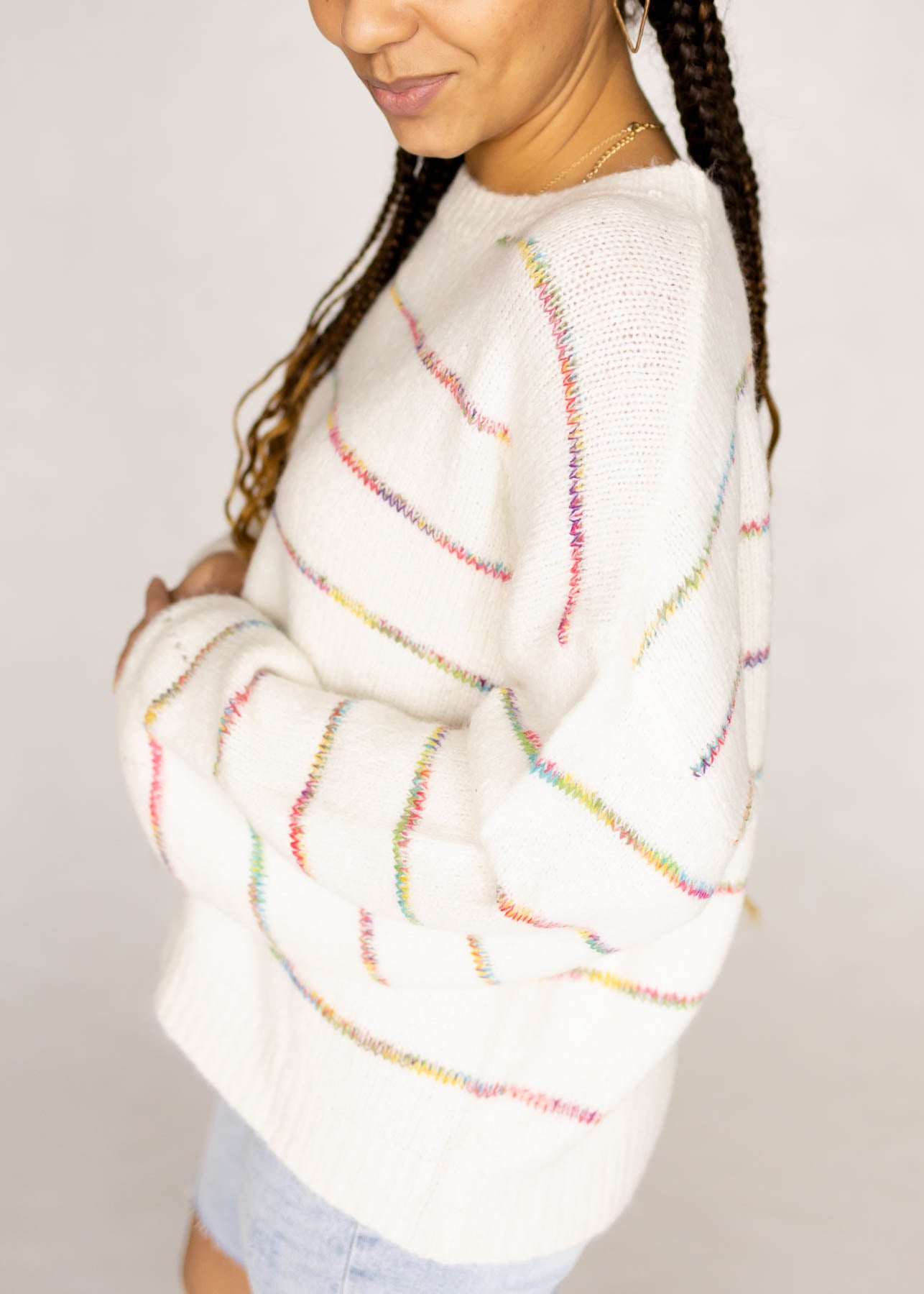 Side view of a ivory sweater