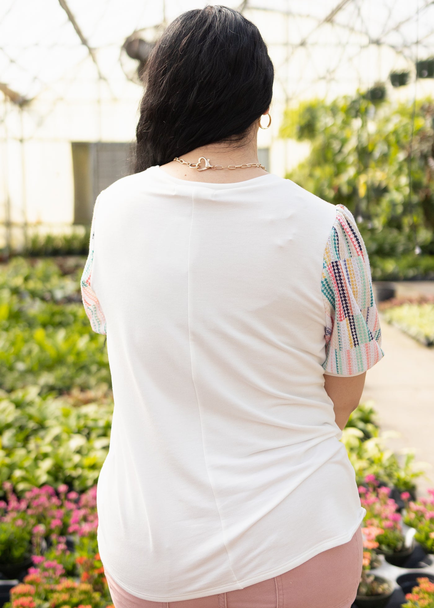 Back view of a white top with colorful sleeves