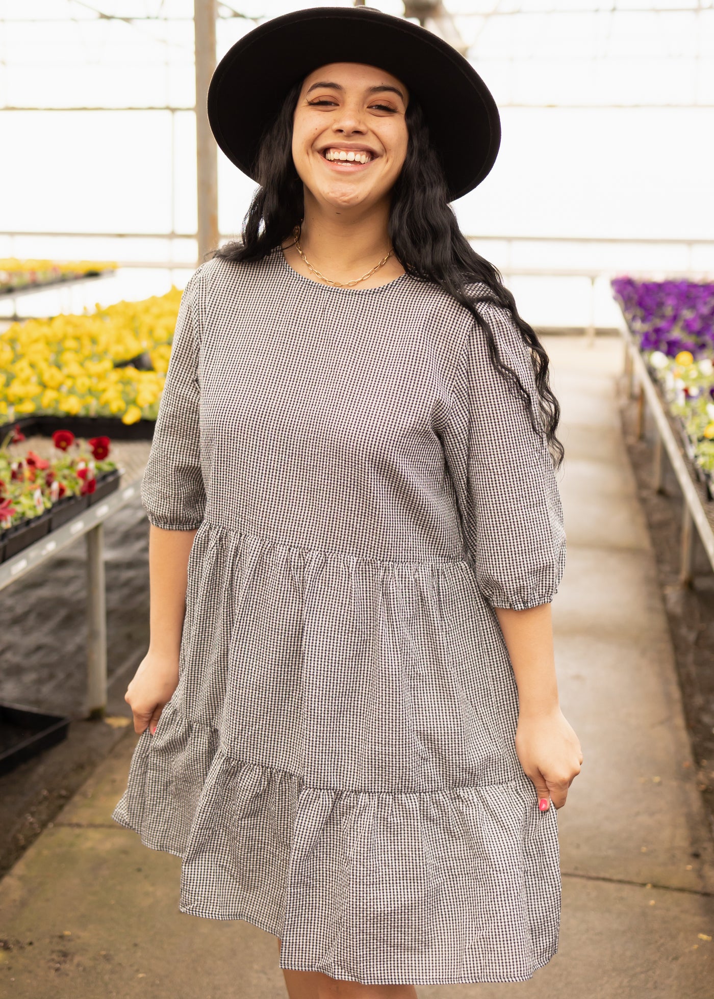 Short sleeve black dress with checkered pattern and tiered skirt